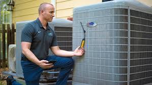 Technician inspecting a residential outdoor air-conditioning unit